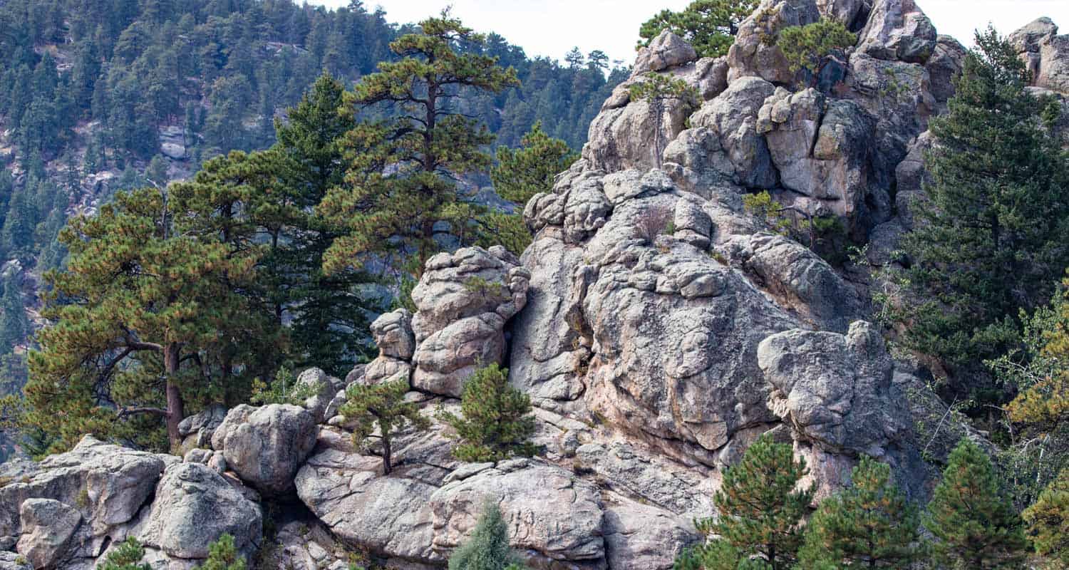 rock formation with pine trees at alderfer 3 sisters park in evergreen colorado