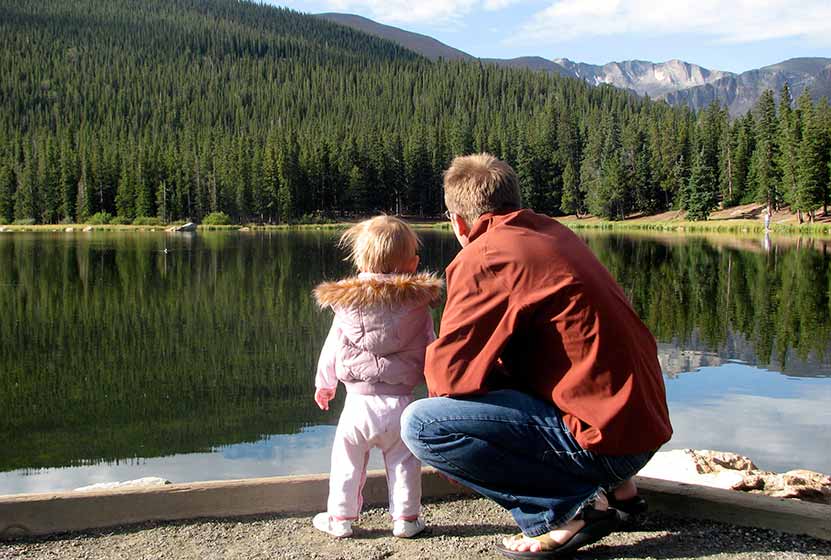 child and father at shore of echo lake colorado