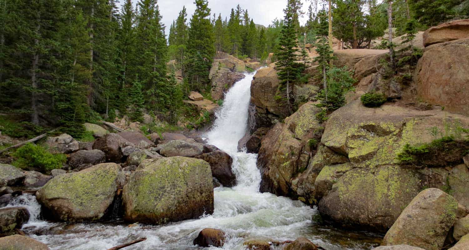 alberta falls waterfall in granite canyon with cascades in foreground in rocky mountain national park