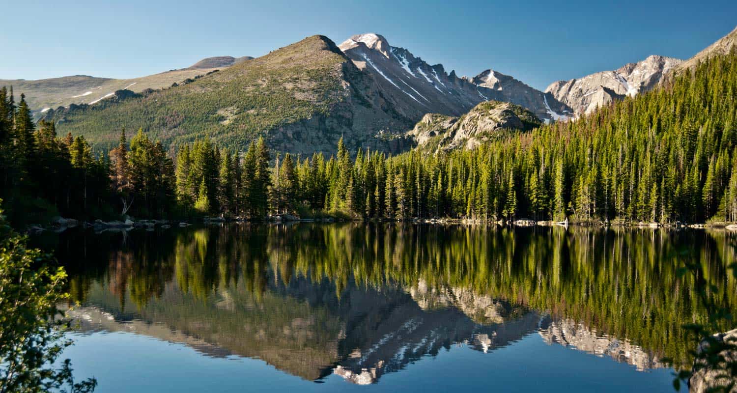 bear lake with mountains of glacier gorge in background along bear lake hike in rocky mountain national park