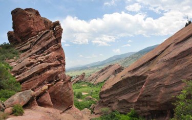 red rocks with blue sky background and green trees along trading post trail red rocks park in Denver Colorado