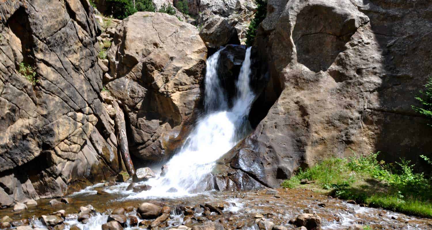 boulder falls waterfall near boulder colorado pouring through canyon into creek below with grey rock cliffs