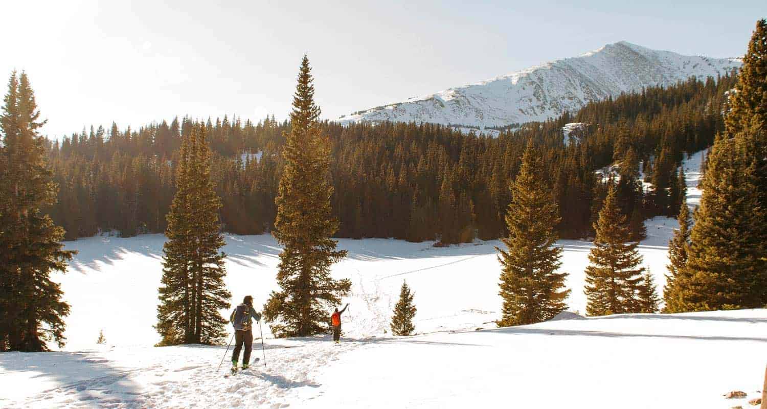 hikers in snow covered landscape with distant landscape winter hikes near denver