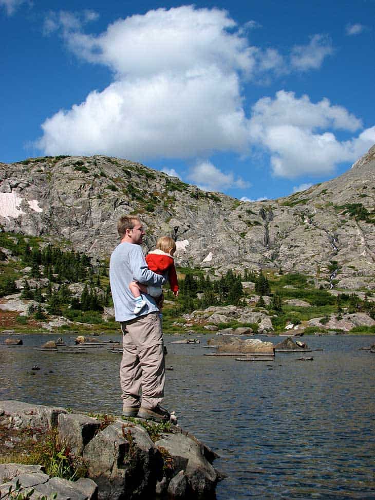 hiker with child at lower mohawk lake in Colorado mountains
