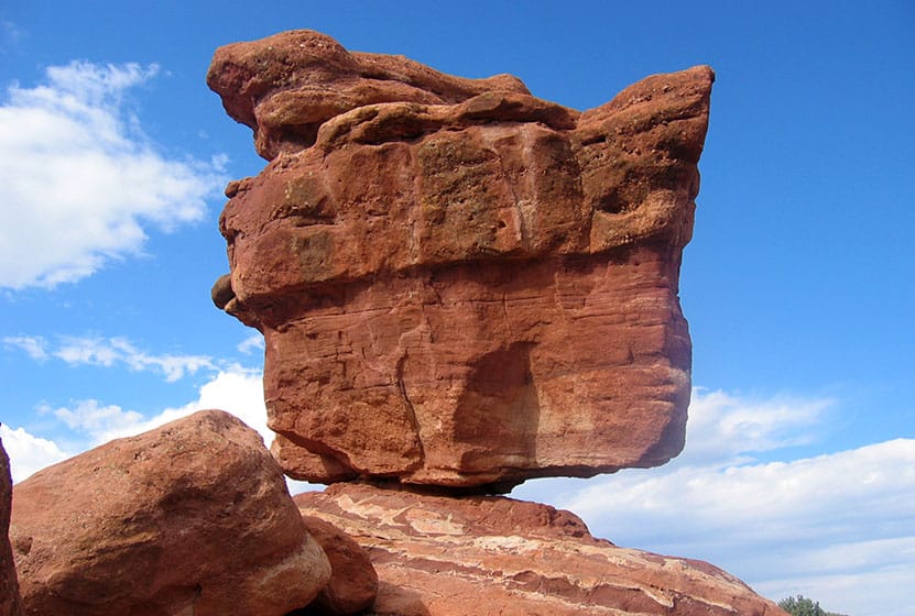 giant red rock balanced on rock fulcrum in garden of the gods
