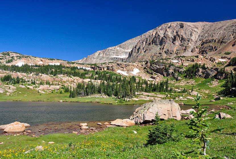 mountain with lion lake beneath it and blue skies on summer day rocky mountain national park in wild basin