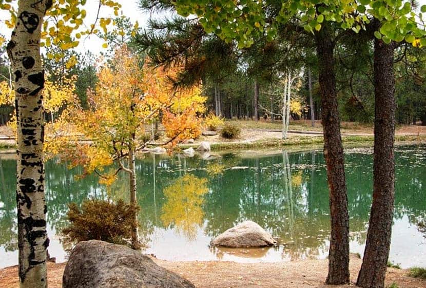 green lake with changing aspens at fox run park near colorado springs at beginning of the fallen timbers loop hike