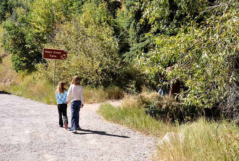 young hikers following sign to hays creek falls in colorado