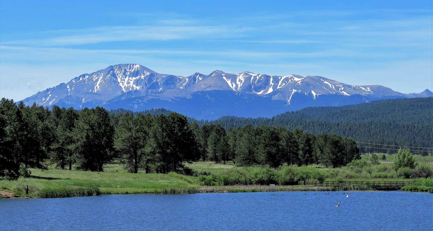 manitou lake near colorado springs with pikes peak in the background along hike