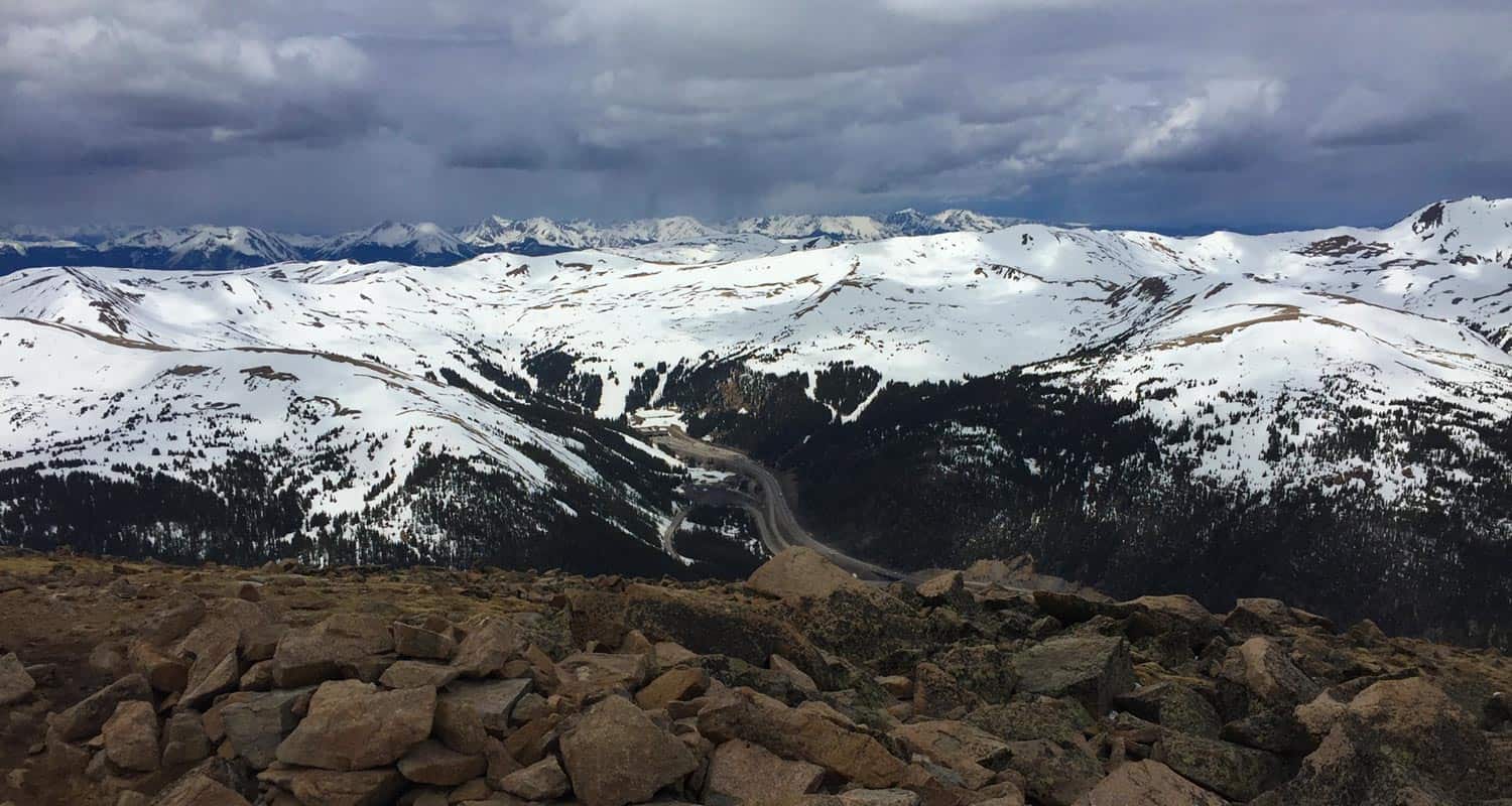 view from the summit of mt sniktau looking toward interstate 70 and weather rolling in on hike near denver