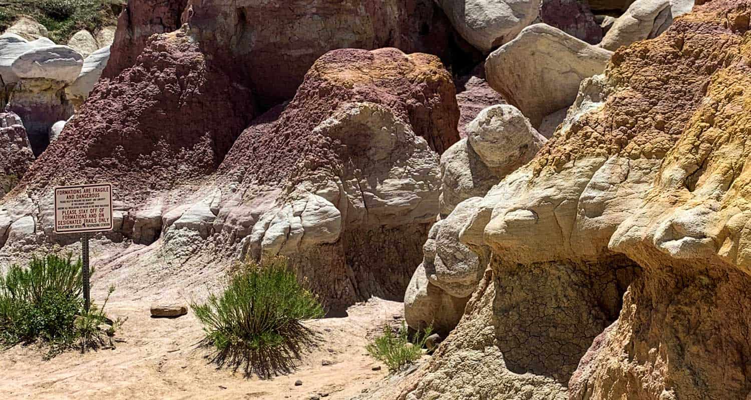 paint mines sign prohbiting climbing with sandstone formations in background